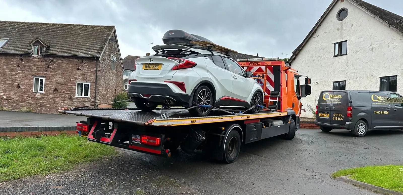White Toyota C-HR loaded on a flatbed recovery truck