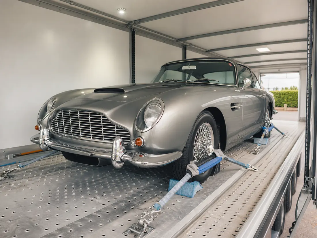 Classic car secured inside an enclosed transporter
